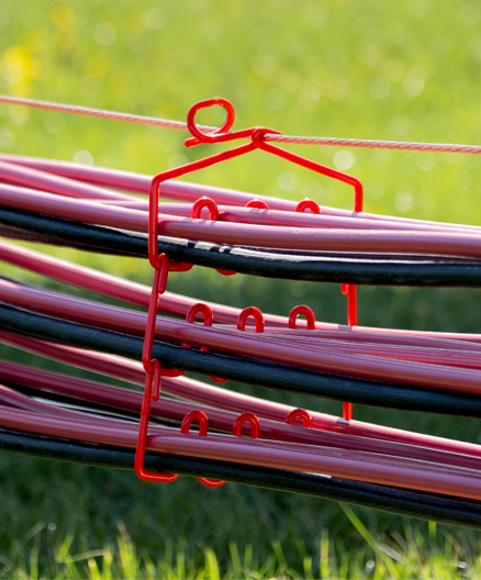 Red and black electrical cables organized in a CAB ModulAir® rack system at an outdoor installation site.